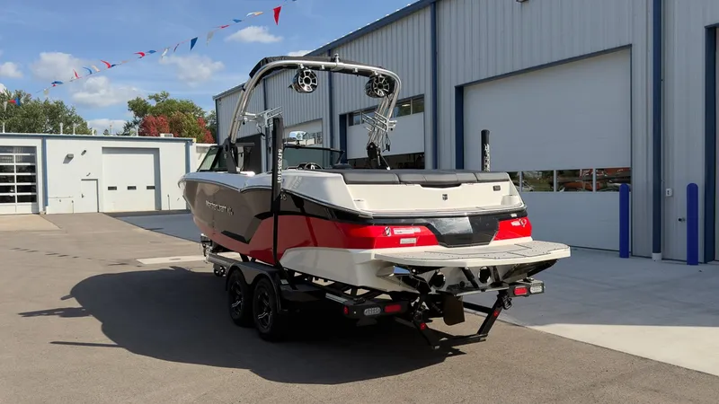 Slide: The Image of A 2021 MasterCraft NXT24 on a trailer outside a warehouse. - 3