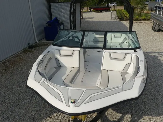 Slide: The Image of A 2018 Yamaha AR190 boat with white interior, parked on a gravel lot. - 30