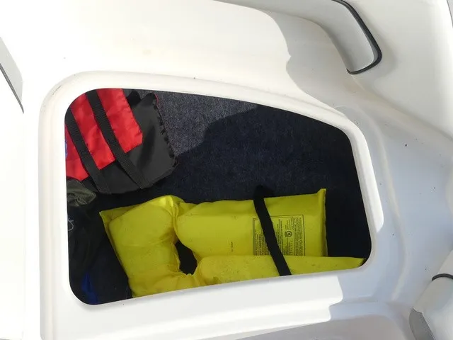 Slide: The Image of A storage compartment in a Yamaha AR190 boat with a yellow life jacket and a bag. - 16