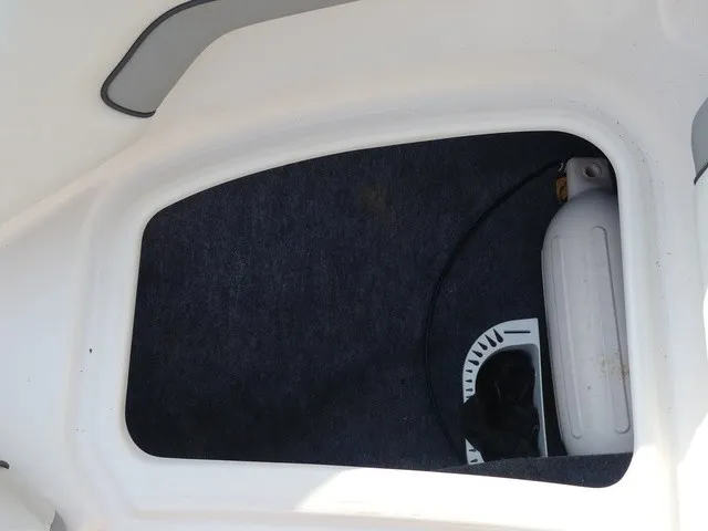 Slide: The Image of A storage compartment inside a boat with a fire extinguisher. - 17