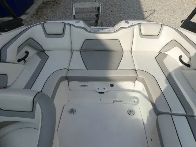 Slide: The Image of The image shows the seating area of a 2018 Yamaha AR190 boat with gray and white upholstery. - 20