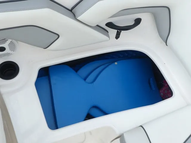 Slide: The Image of A storage compartment inside a Yamaha AR190 boat with a blue mat. - 26