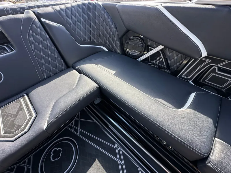Slide: The Image of The image shows luxurious, upholstered seating with modern design and contrasting stitching in a boat. - 14