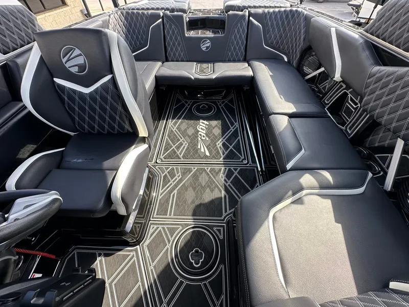 Slide: The Image of The image shows the luxurious interior of a 2024 Tigé 22RZX boat with stylish upholstered seating. - 28