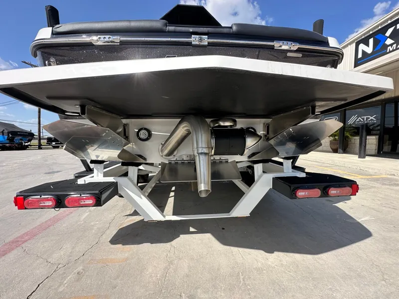 Slide: The Image of The rear of a 2024 Tigé 22RZX boat with exhaust and lights. - 5
