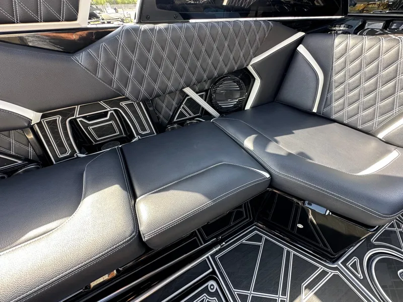 Slide: The Image of The image shows the luxurious interior of a 2024 Tigé 22RZX with black, quilted seating. - 15