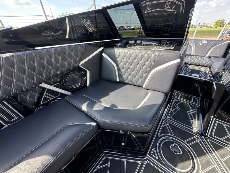 Slide: The Image of The image shows the luxurious interior of a 2024 Tigé 22RZX with black quilted seating. - 16