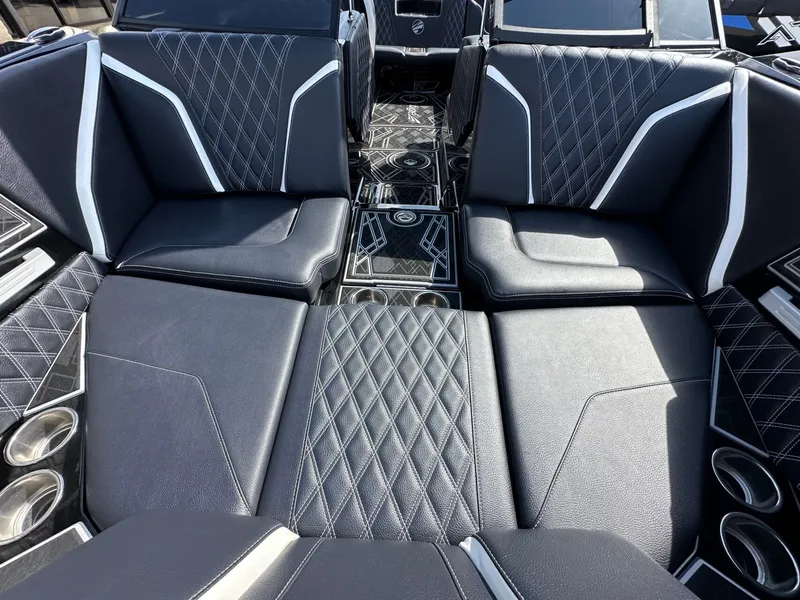 Slide: The Image of Luxurious black upholstery with white accents in the interior of a 2024 Tigé 22RZX boat. - 24