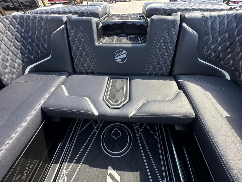 Slide: The Image of The image shows the luxurious interior of a 2024 Tigé 22RZX boat with sleek black seating. - 13