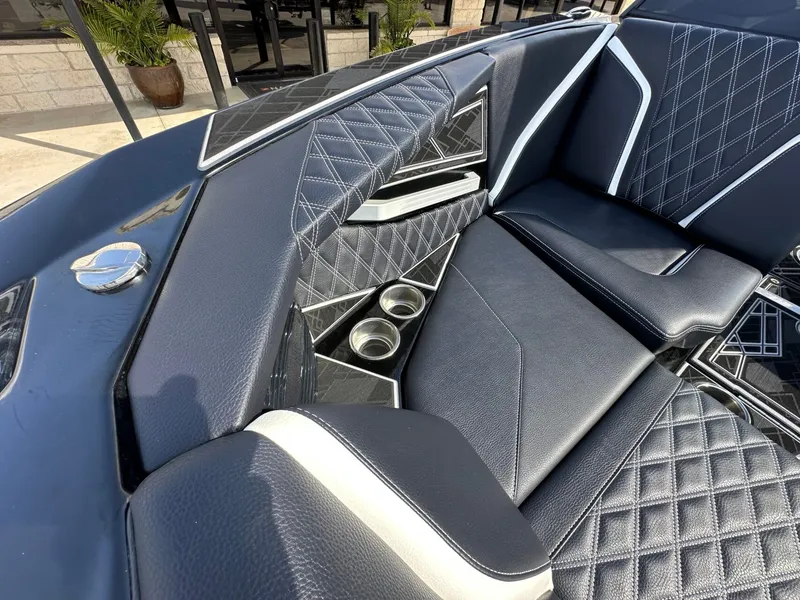 Slide: The Image of The image shows the luxurious interior of a 2024 Tigé 22RZX boat with sleek seating. - 23
