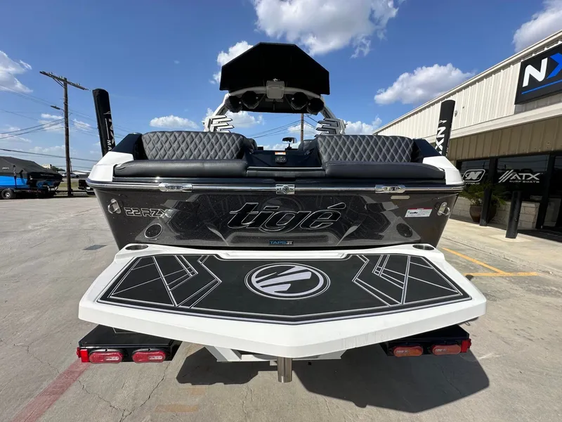 Slide: The Image of The image shows the rear of a 2024 Tigé 22RZX boat with stylish design. - 4