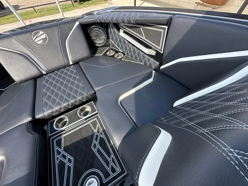 Slide: The Image of The image shows the luxurious interior of a 2024 Tigé 22RZX boat with sleek black upholstery. - 22