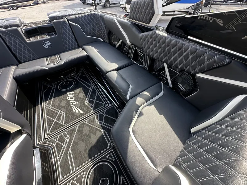 Slide: The Image of The image shows the luxurious interior of a 2024 Tigé 22RZX boat with stylish black upholstery. - 29