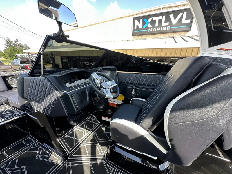 Slide: The Image of The image shows the cockpit of a 2024 Tigé 22RZX boat with modern seating and a sleek dashboard. - 18