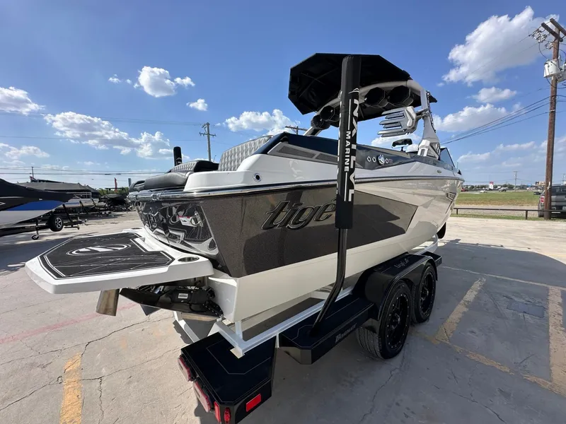 Slide: The Image of A 2024 Tigé 22RZX boat on a trailer, featuring sleek design and modern tower. - 6
