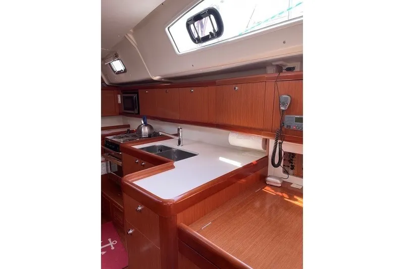 Slide: The Image of Interior of 2011 Beneteau Oceanis 43 yacht kitchen with wooden cabinetry and modern appliances. - 5