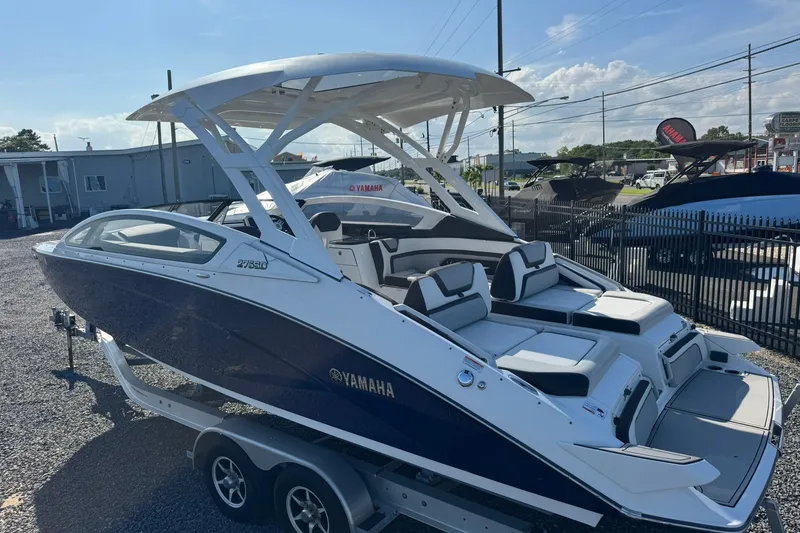 Slide: The Image of 2020 Yamaha Boats 275SD, sleek design, dual console, on trailer, outdoor display. - 14