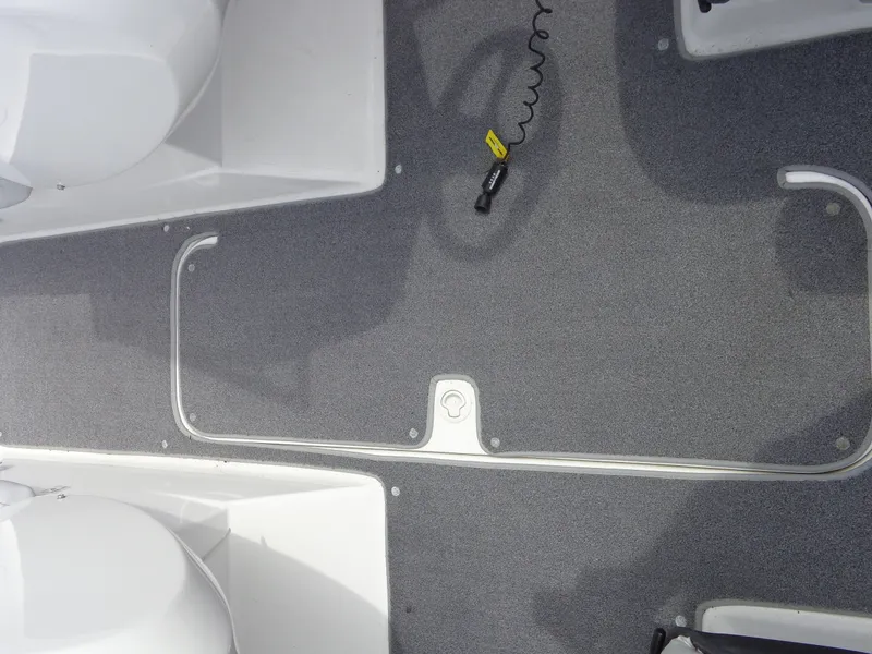 Slide: The Image of The interior of a Sea-Doo sport boat with gray carpet flooring and white seats. - 38