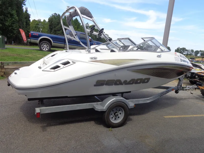 Slide: The Image of A white Sea-Doo Sport Boat, model 180 Challenger from 2008, is on a trailer. - 2