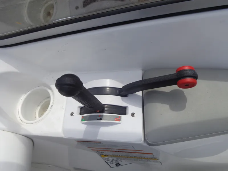 Slide: The Image of Close-up of the control levers on a 2008 Sea-Doo Sport Boats 180 Challenger. - 12