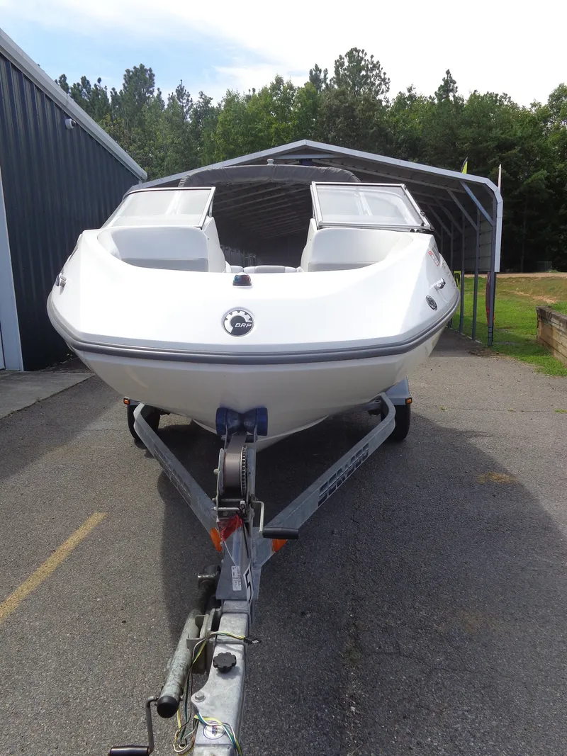Slide: The Image of A white 2008 Sea-Doo Sport Boats 180 Challenger on a trailer in front of a building. - 3