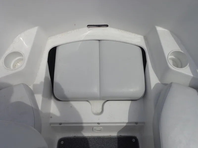 Slide: The Image of The image shows the seating area of a Sea-Doo sport boat with white cushions and cup holders. - 25