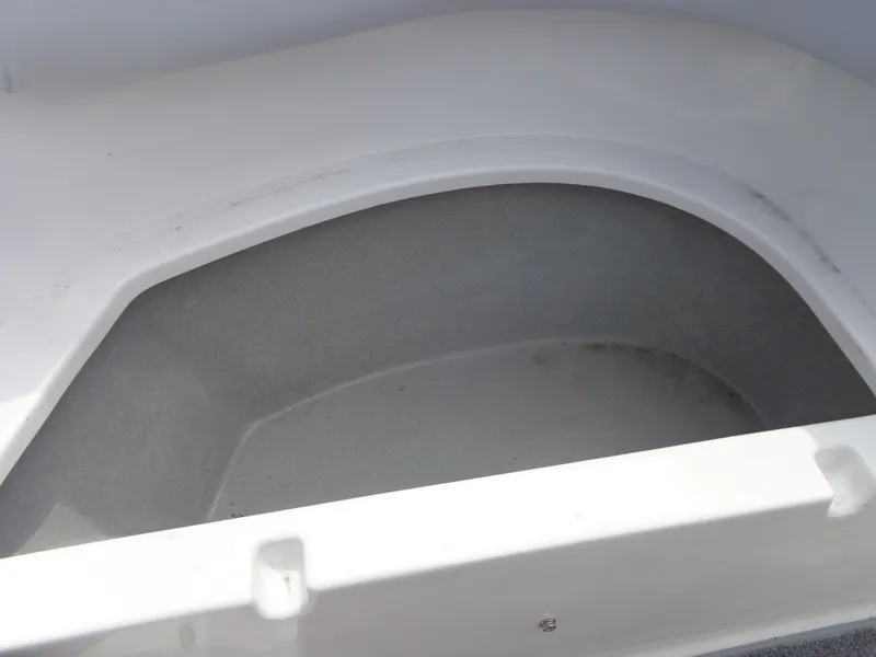 Slide: The Image of An open storage compartment in the boat with smooth, white walls. - 36