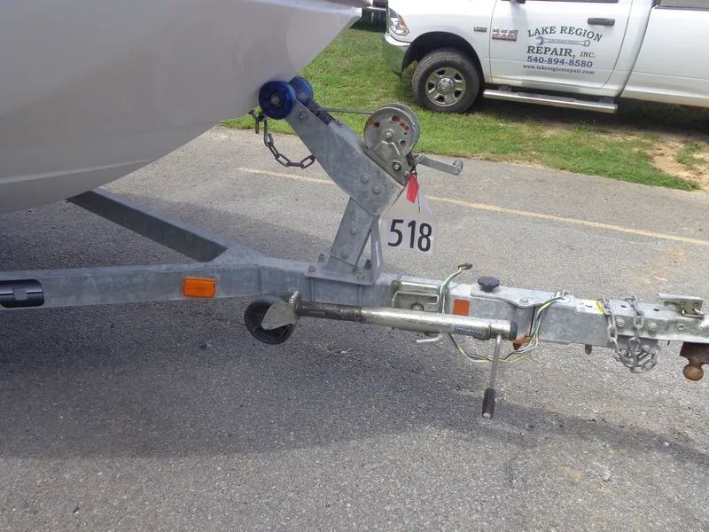 Slide: The Image of A boat trailer with a winch and a numbered tag is parked on a lot. - 50