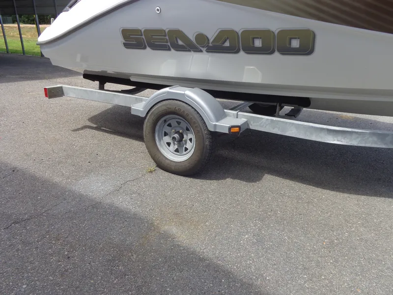 Slide: The Image of A Sea-Doo sport boat on a trailer, partially visible. It is parked on a paved area. - 39