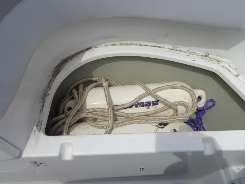 Slide: The Image of A storage compartment in a Sea-Doo sport boat with a fender and ropes. - 37