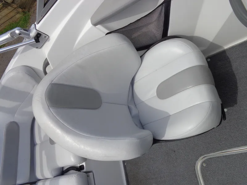 Slide: The Image of A white and gray seat in a boat with gray carpeting. - 22