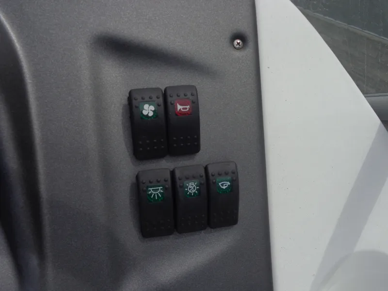 Slide: The Image of Close-up of four toggle switches on a boat panel. - 15