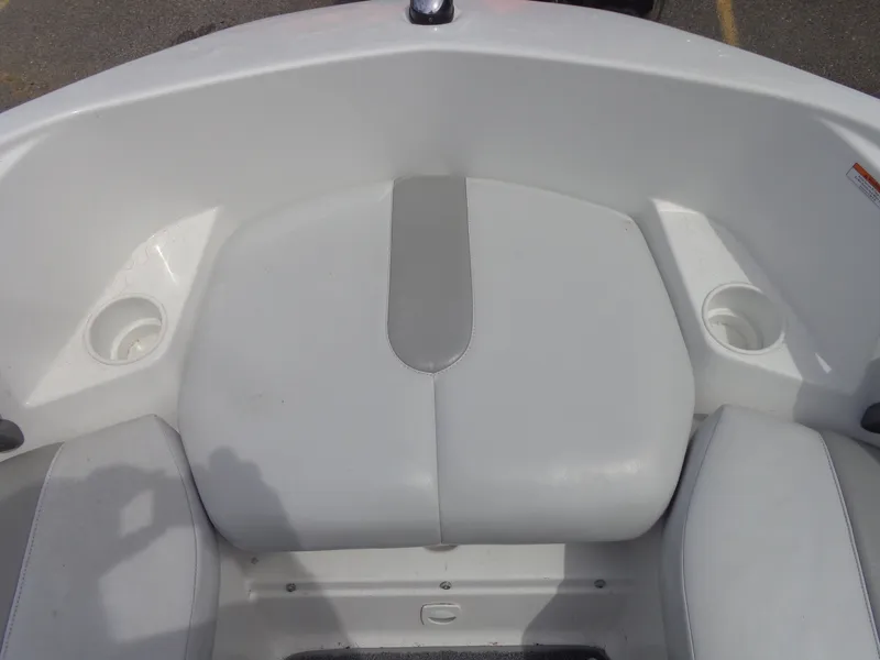 Slide: The Image of The image shows the bow area of a Sea-Doo sport boat with white cushions and cup holders. - 24