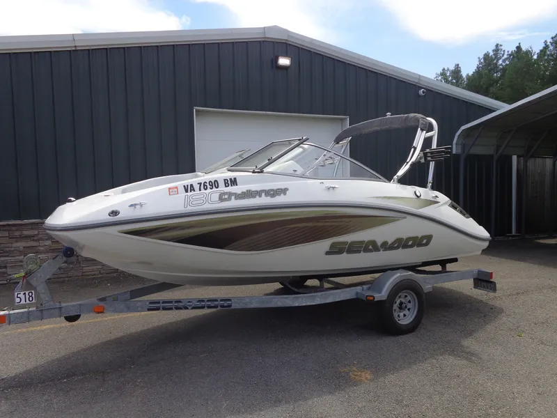 The Image of A white 2008 Sea-Doo Sport Boat, model 180 Challenger, on a trailer in front of a building. - 1