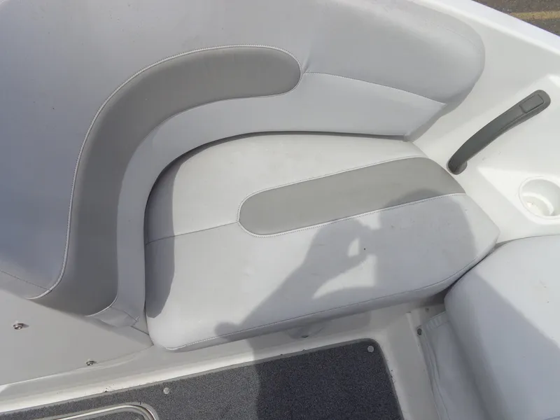 Slide: The Image of A gray and white seat in a boat with a cup holder beside it. - 26
