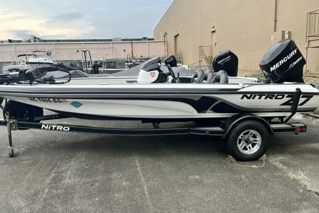 The Image of 2011 Nitro Z-7 boat with Mercury engine on trailer, parked outdoors. - 1