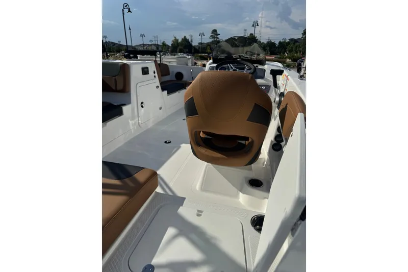 Slide: The Image of 2027 Tahoe 2150 boat interior with brown seating and modern dashboard. - 1