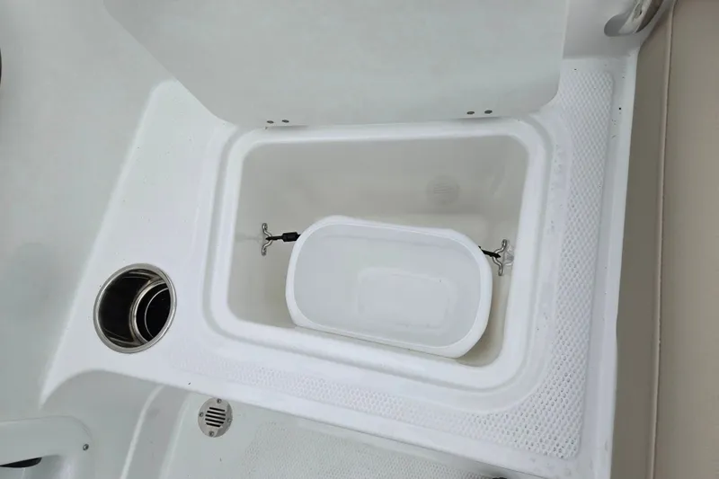 Slide: The Image of Storage compartment in 2027 Tahoe 2150 boat, featuring integrated cup holder and drainage system. - 18