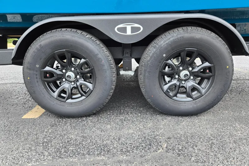 Slide: The Image of 2027 Tahoe 2150 trailer wheels on asphalt, featuring black alloy rims and Load Star tires. - 9