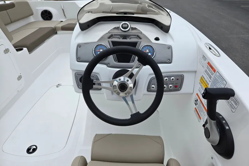 Slide: The Image of Steering console of a 2027 Tahoe 2150 boat with modern controls and seating. - 12