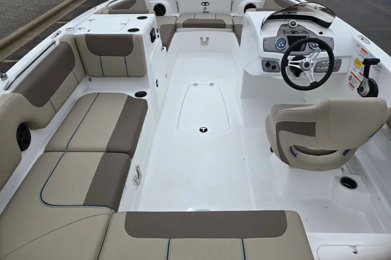 Slide: The Image of 2027 Tahoe 2150 boat interior with beige seating and modern dashboard. - 11