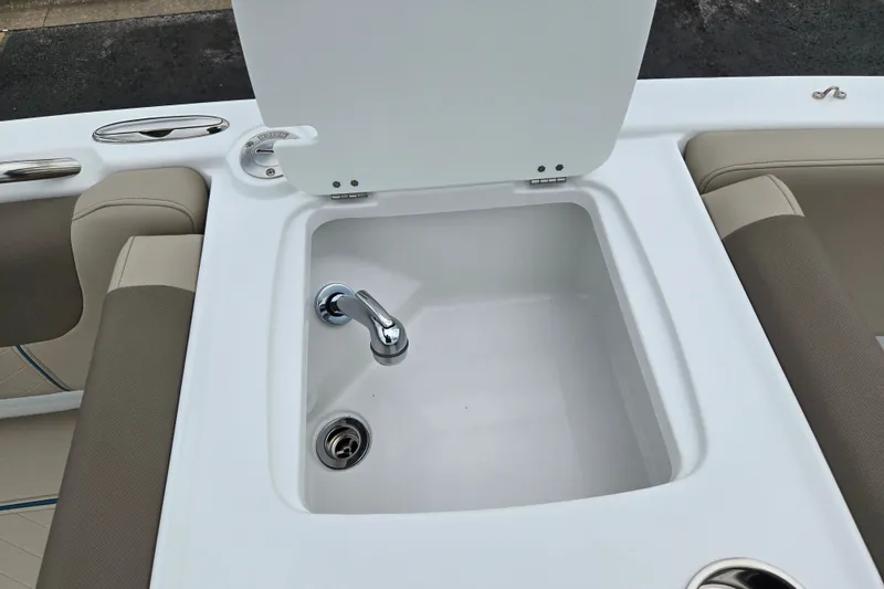 Slide: The Image of 2027 Tahoe 2150 boat sink with faucet and seating area. - 17