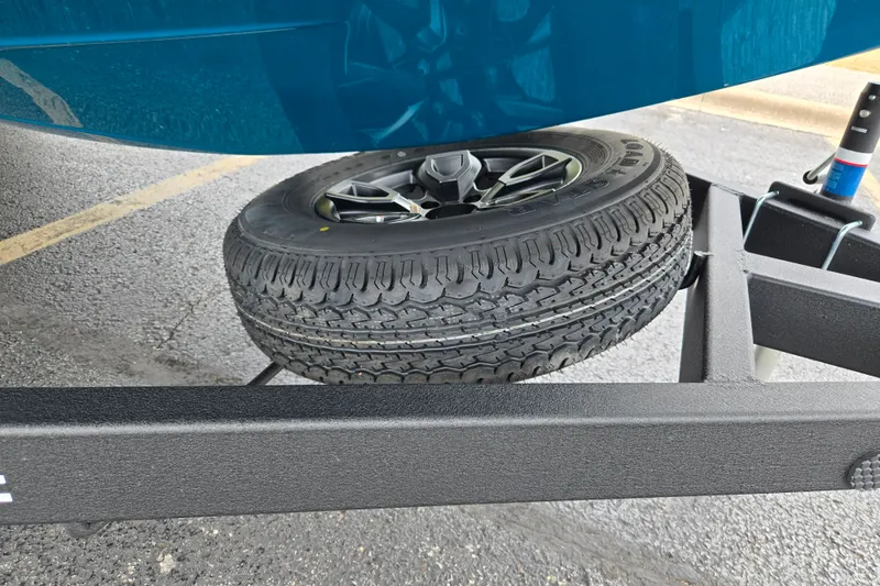 Slide: The Image of Spare tire mounted on a Tahoe 2150 trailer, 2027 model, parked on asphalt. - 10