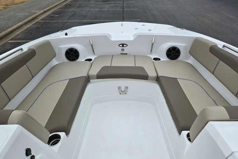 Slide: The Image of Spacious seating area of 2027 Tahoe 2150 boat with beige cushions and speakers. - 13