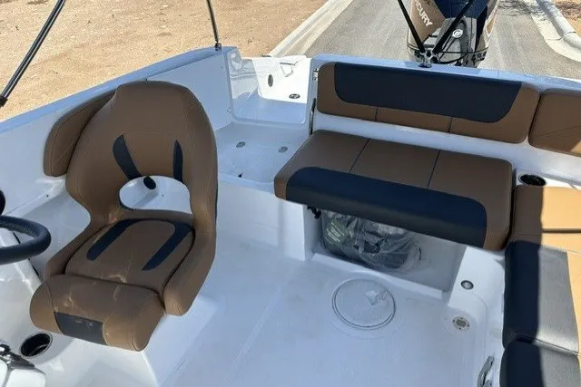 Slide: The Image of Interior of a 2027 Tahoe 2150 boat with brown and black seating. - 18