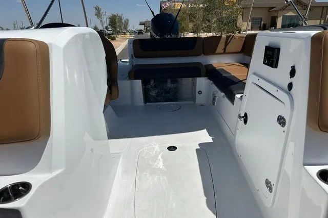 Slide: The Image of 2027 Tahoe 2150 boat interior with white deck and brown seating. - 13