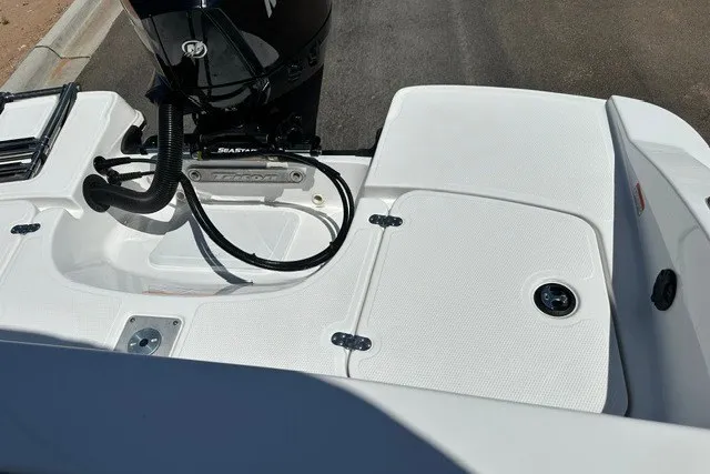 Slide: The Image of 2027 Tahoe 2150 boat deck with motor, featuring sleek white design and modern fittings. - 20