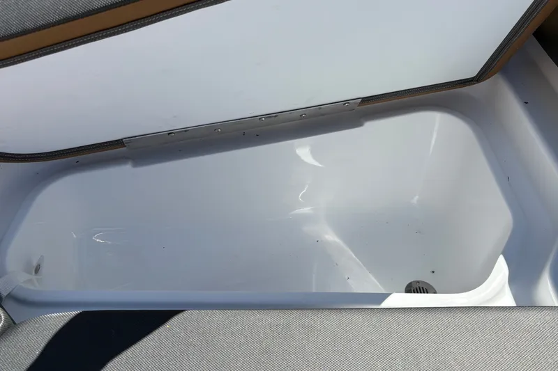 Slide: The Image of An open storage compartment on a boat with a white, clean interior. - 26