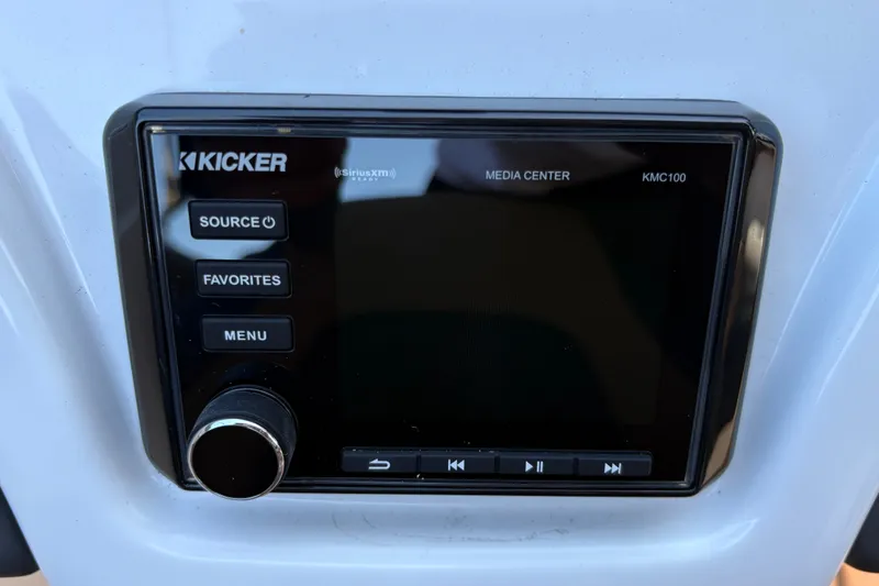 Slide: The Image of Kicker media center KMC100 in 2027 Tahoe 210 S boat, featuring control buttons. - 30