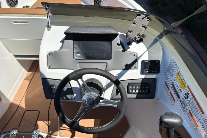 Slide: The Image of Steering console of 2027 Tahoe 210 S boat with modern controls and dashboard. - 16